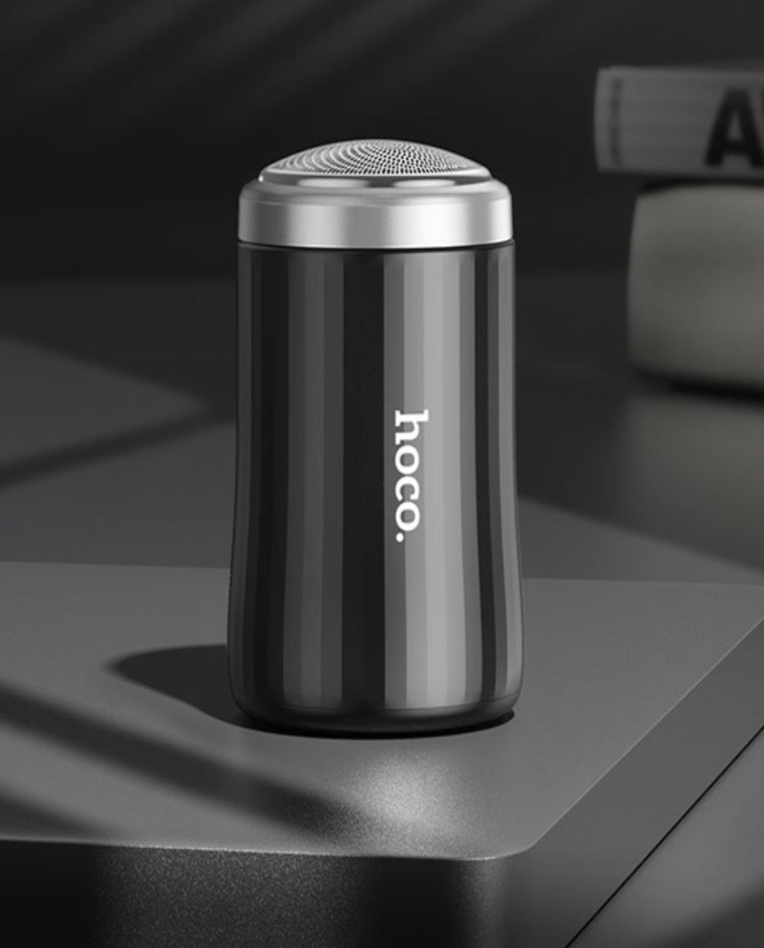 hoco. portable shaver on a dark surface with 'hoco.' branding.